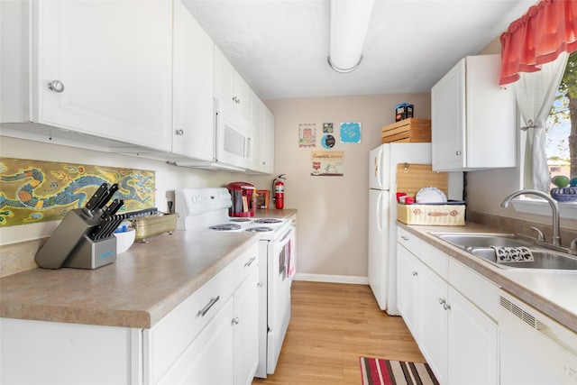 23718 E Webb Rd, Porter, TX 77365 - kitchen with white appliances, a sink, white cabinets, light wood finished floors, and light countertops