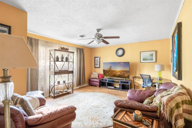 23718 E Webb Rd, Porter, TX 77365 - living area with ceiling fan, wood finished floors, and a textured ceiling