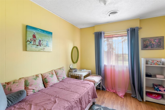 23718 E Webb Rd, Porter, TX 77365 - bedroom with wood finished floors and a textured ceiling