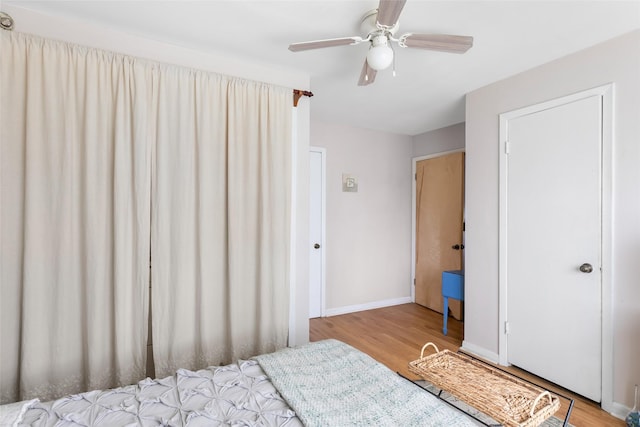 23718 E Webb Rd, Porter, TX 77365 - bedroom with wood finished floors, baseboards, and a ceiling fan