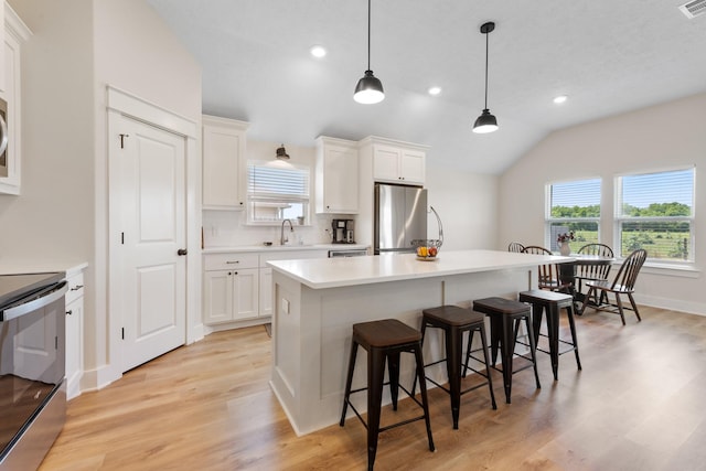 263 Brazos Bnd, Snook, TX 77879 - kitchen with appliances with stainless steel finishes, a sink, a breakfast bar, healthy amount of natural light, and lofted ceiling