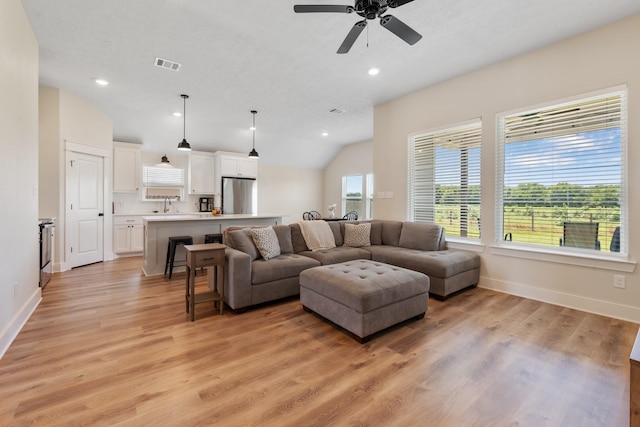263 Brazos Bnd, Snook, TX 77879 - living room with baseboards, light wood-type flooring, lofted ceiling, a ceiling fan, and recessed lighting