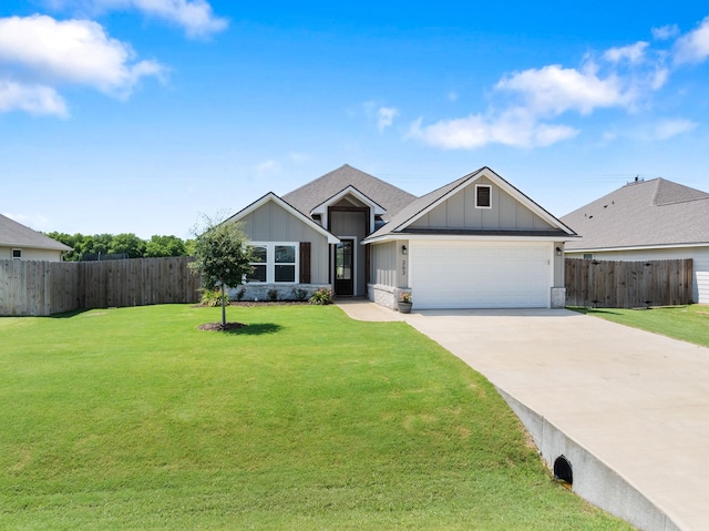 263 Brazos Bnd, Snook, TX 77879 - view of front facade with board and batten siding, an attached garage, and concrete driveway