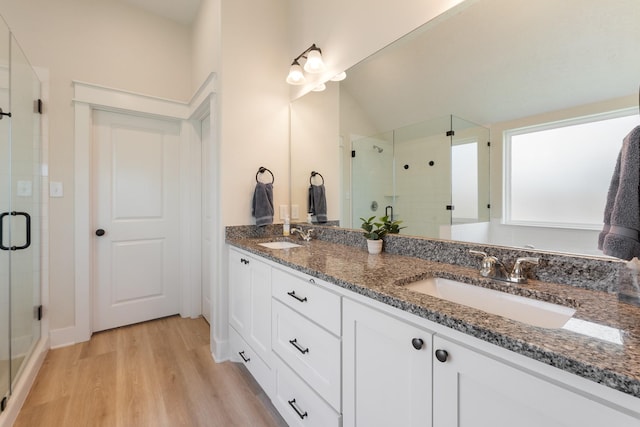 263 Brazos Bnd, Snook, TX 77879 - full bath with a stall shower, double vanity, and wood finished floors