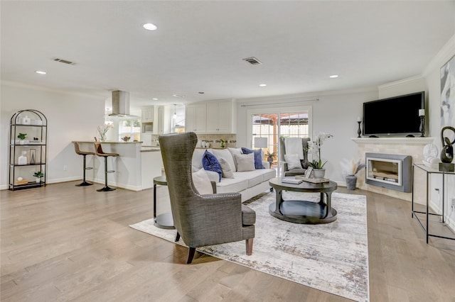 4414 Arnell Dr, Houston, TX 77018 - living area with crown molding, light wood-type flooring, baseboards, recessed lighting, and a fireplace