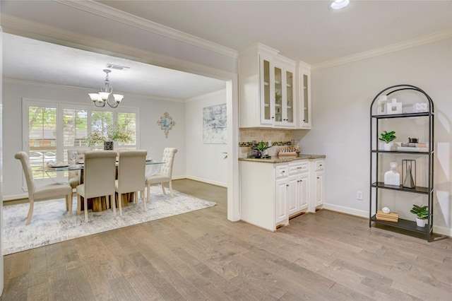 4414 Arnell Dr, Houston, TX 77018 - dining room featuring a chandelier, light wood-type flooring, ornamental molding, baseboards, and recessed lighting