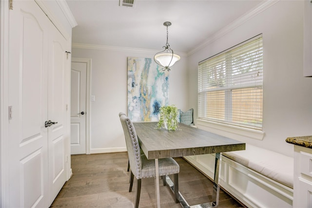 4414 Arnell Dr, Houston, TX 77018 - dining area featuring crown molding, wood finished floors, and baseboards