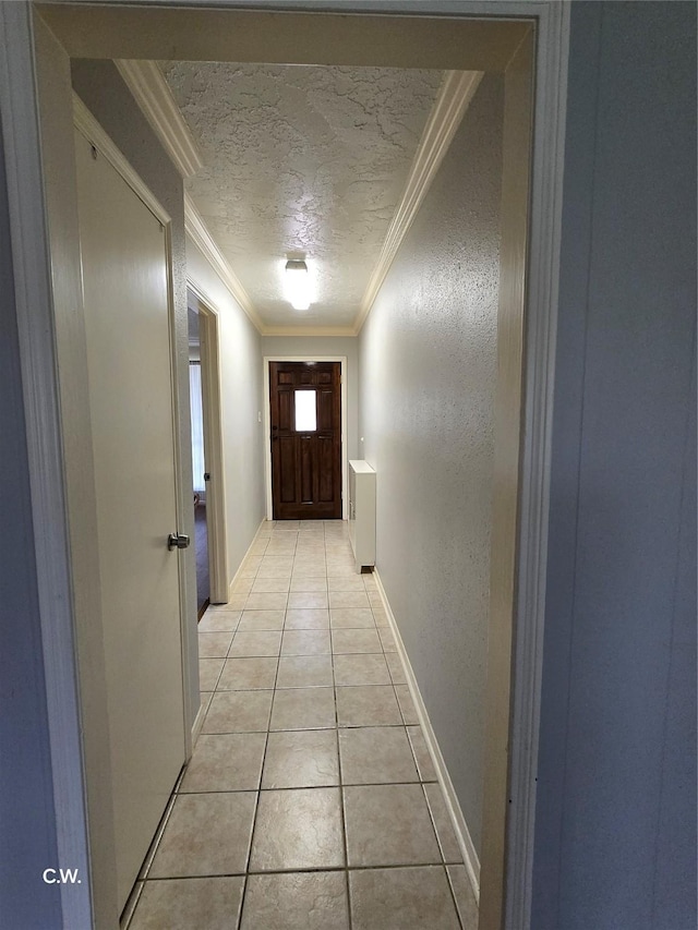 11834 Mulholland Dr, Meadows Place, TX 77477 - corridor with ornamental molding, light tile patterned flooring, a textured ceiling, and baseboards