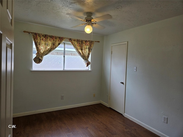 11834 Mulholland Dr, Meadows Place, TX 77477 - spare room featuring dark wood-style floors, ceiling fan, baseboards, and a textured ceiling