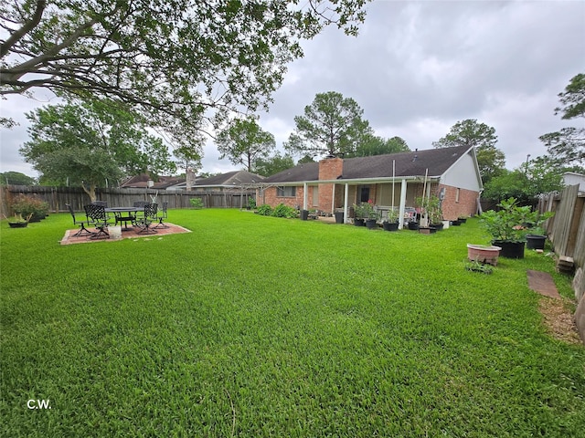 11834 Mulholland Dr, Meadows Place, TX 77477 - view of yard featuring an outdoor fire pit and a patio area