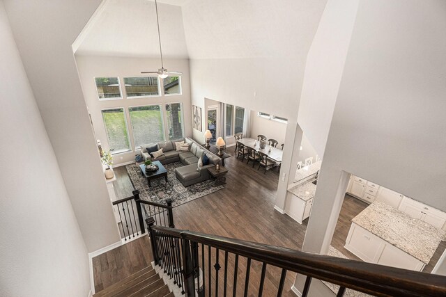 5711 Greenwood Colony Ct, Houston, TX 77059 - stairs with a high ceiling, wood finished floors, a ceiling fan, and baseboards