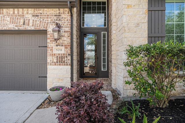 5711 Greenwood Colony Ct, Houston, TX 77059 - doorway to property featuring brick siding, an attached garage, and stone siding
