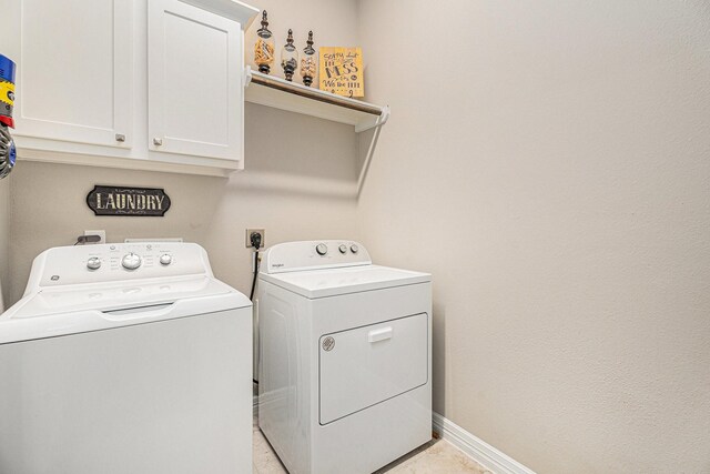 5711 Greenwood Colony Ct, Houston, TX 77059 - washroom with washer and clothes dryer, cabinet space, and baseboards