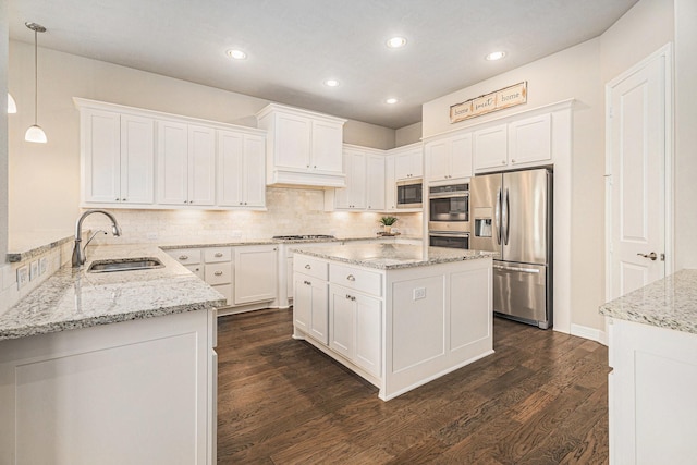 5711 Greenwood Colony Ct, Houston, TX 77059 - kitchen with stainless steel appliances, a sink, dark wood-style floors, white cabinets, and recessed lighting