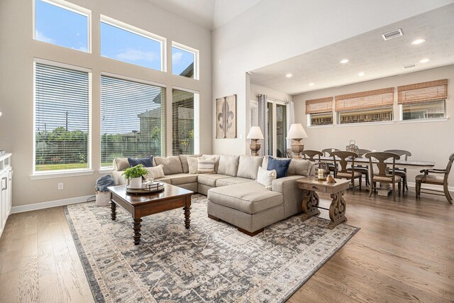 5711 Greenwood Colony Ct, Houston, TX 77059 - living room featuring wood finished floors, plenty of natural light, baseboards, recessed lighting, and a towering ceiling