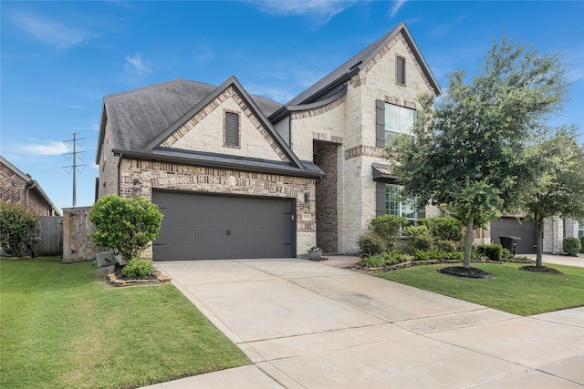 5711 Greenwood Colony Ct, Houston, TX 77059 - french country style house featuring driveway, roof with shingles, stone siding, brick siding, and an attached garage