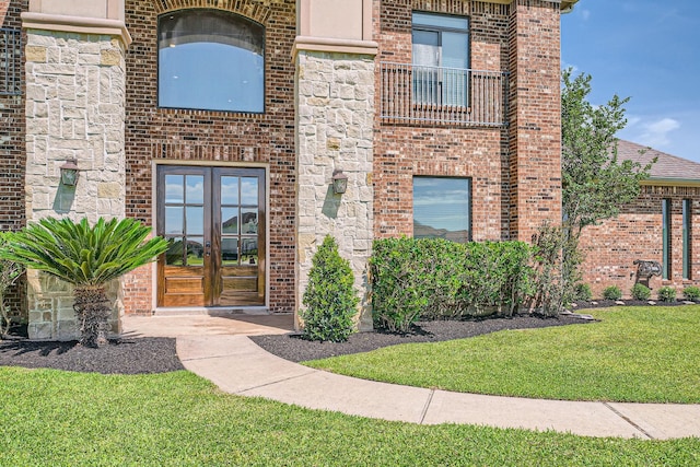 1102 Nautical Ln, Richmond, TX 77469 - doorway to property featuring french doors, brick siding, and a yard