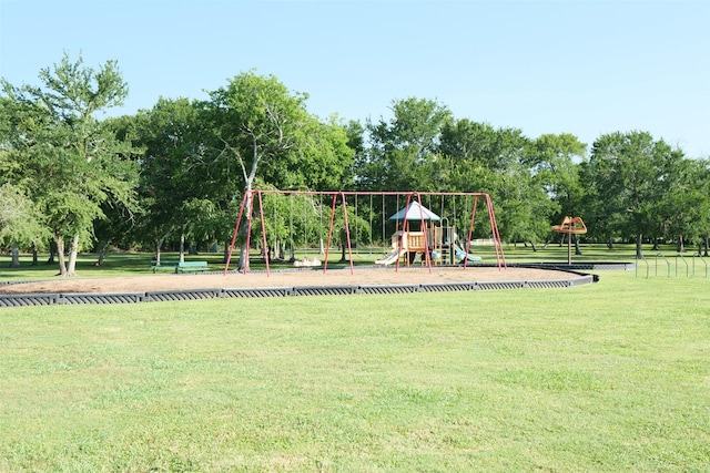 1102 Nautical Ln, Richmond, TX 77469 - communal playground with a yard and view of wooded area