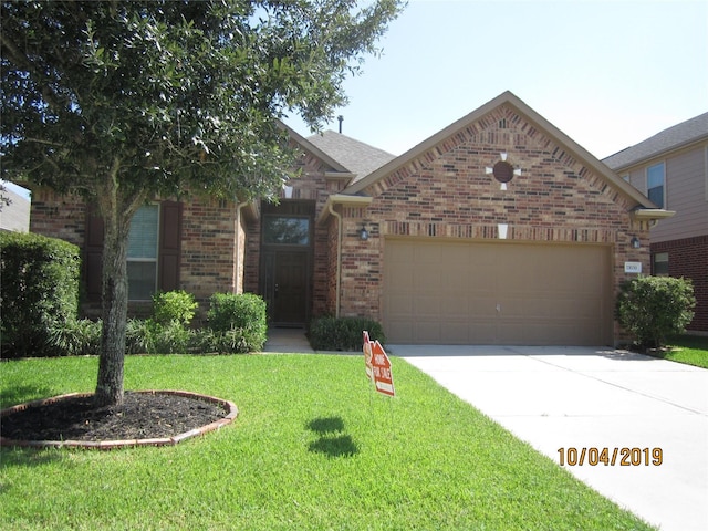 11030 Jacob Crossing Dr, Richmond, TX 77406 - view of front facade featuring an attached garage, driveway, brick siding, and a front yard