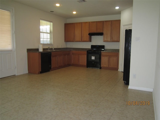 11030 Jacob Crossing Dr, Richmond, TX 77406 - kitchen featuring black appliances, under cabinet range hood, dark countertops, brown cabinets, and recessed lighting