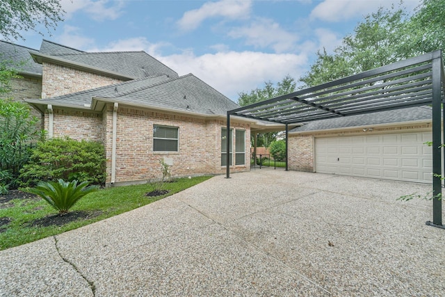 13331 Brentonwood Ln, Houston, TX 77077 - rear view of property with concrete driveway, roof with shingles, a garage, and brick siding