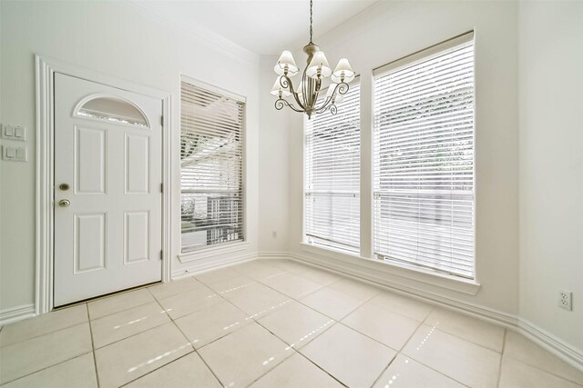 13331 Brentonwood Ln, Houston, TX 77077 - unfurnished dining area with a chandelier, tile patterned floors, crown molding, and baseboards