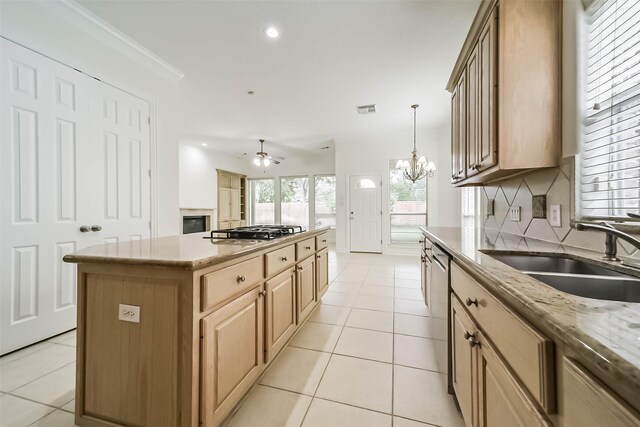 13331 Brentonwood Ln, Houston, TX 77077 - kitchen with a sink, stainless steel appliances, a kitchen island, light brown cabinetry, and light tile patterned floors