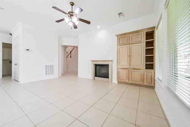 13331 Brentonwood Ln, Houston, TX 77077 - unfurnished living room featuring a ceiling fan, a glass covered fireplace, ornamental molding, light tile patterned floors, and recessed lighting