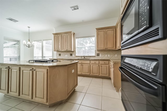 13331 Brentonwood Ln, Houston, TX 77077 - kitchen featuring black appliances, a chandelier, a center island, light brown cabinets, and decorative backsplash