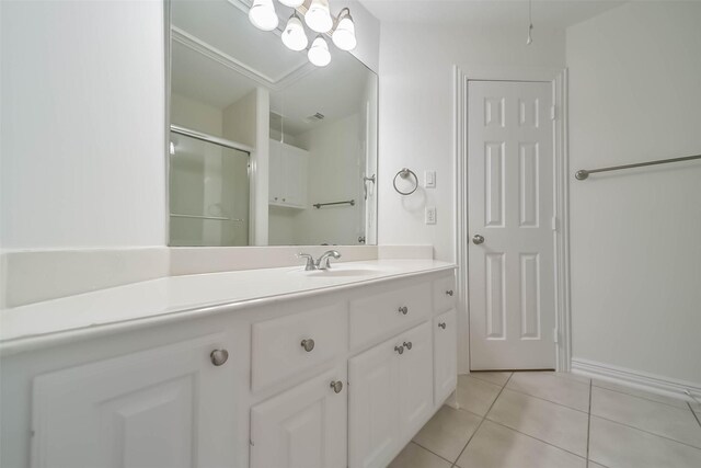 13331 Brentonwood Ln, Houston, TX 77077 - bathroom with vanity, tile patterned flooring, an enclosed shower, and baseboards