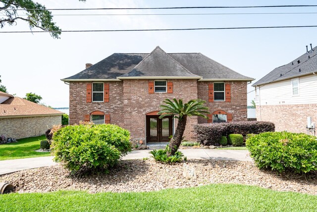 3623 Shore Shadows Dr, Crosby, TX 77532 - view of front of house featuring french doors, brick siding, and a chimney