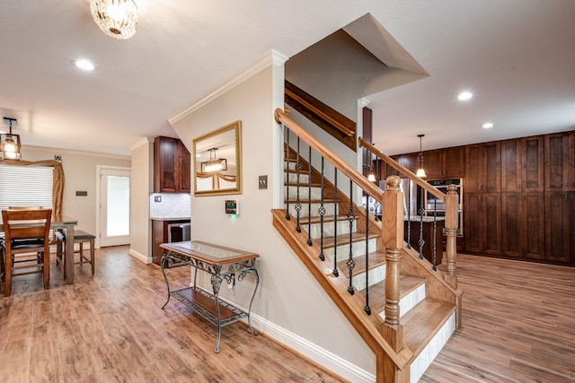 3623 Shore Shadows Dr, Crosby, TX 77532 - stairway featuring crown molding, baseboards, wood finished floors, recessed lighting, and a chandelier