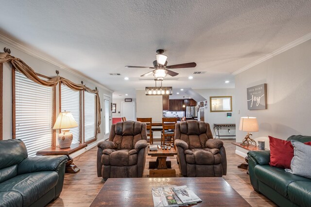 3623 Shore Shadows Dr, Crosby, TX 77532 - living room featuring a ceiling fan, ornamental molding, wood finished floors, a textured ceiling, and baseboards