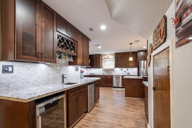 3623 Shore Shadows Dr, Crosby, TX 77532 - kitchen with beverage cooler, appliances with stainless steel finishes, a sink, backsplash, and recessed lighting