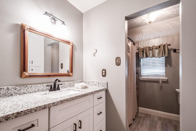 3623 Shore Shadows Dr, Crosby, TX 77532 - full bath featuring vanity, toilet, wood finished floors, baseboards, and a shower with curtain