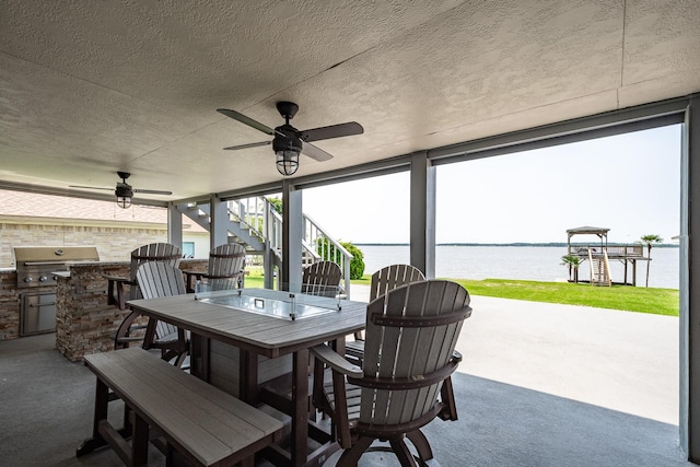 3623 Shore Shadows Dr, Crosby, TX 77532 - view of patio / terrace with stairway, outdoor dining space, a water view, and a ceiling fan