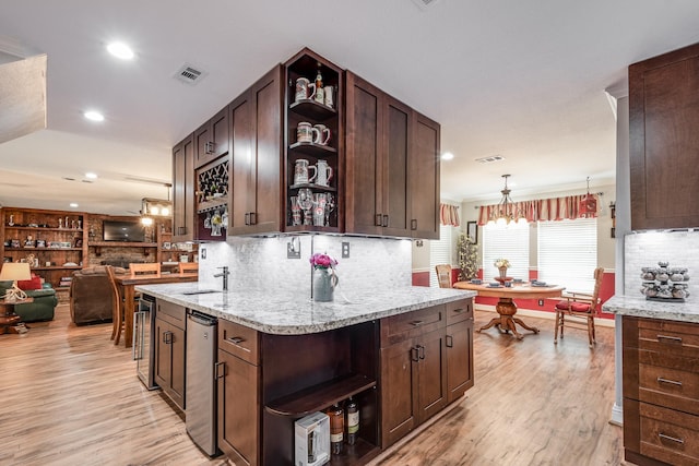 3623 Shore Shadows Dr, Crosby, TX 77532 - kitchen featuring open shelves, light wood finished floors, dark brown cabinets, decorative backsplash, and recessed lighting