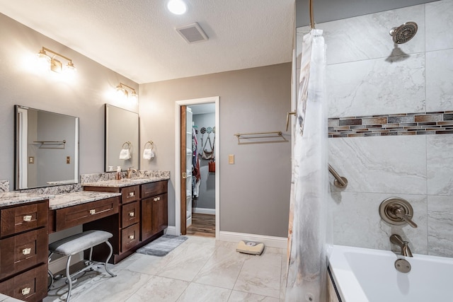 3623 Shore Shadows Dr, Crosby, TX 77532 - full bath featuring vanity, shower / tub combo with curtain, marble look tiles, a textured ceiling, and a walk in closet