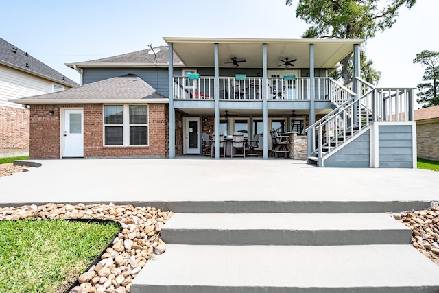3623 Shore Shadows Dr, Crosby, TX 77532 - back of property featuring ceiling fan, stairway, a patio area, roof with shingles, and brick siding
