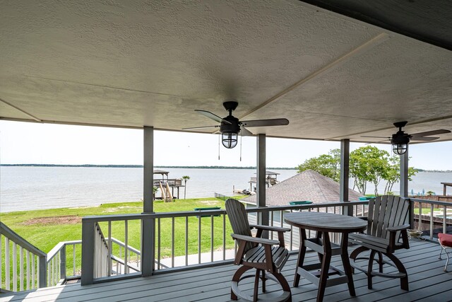 3623 Shore Shadows Dr, Crosby, TX 77532 - wooden terrace featuring ceiling fan, a water view, and a lawn