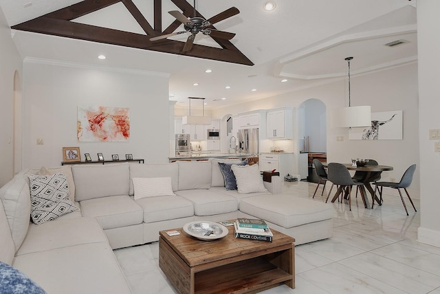 28107 Buena Way, Spring, TX 77386 - living area with arched walkways, ceiling fan, recessed lighting, vaulted ceiling, and ornamental molding
