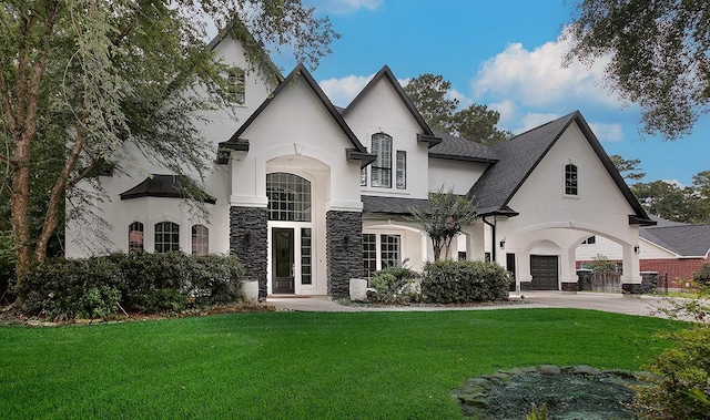 28107 Buena Way, Spring, TX 77386 - view of front facade featuring stone siding, stucco siding, a front yard, and driveway