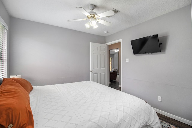 19198 County Road 669e, Alvin, TX 77511 - bedroom with baseboards, wood finished floors, and ceiling fan