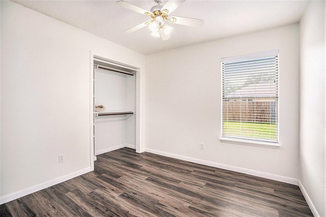 19198 County Road 669e, Alvin, TX 77511 - unfurnished bedroom with dark wood finished floors, baseboards, a closet, and ceiling fan