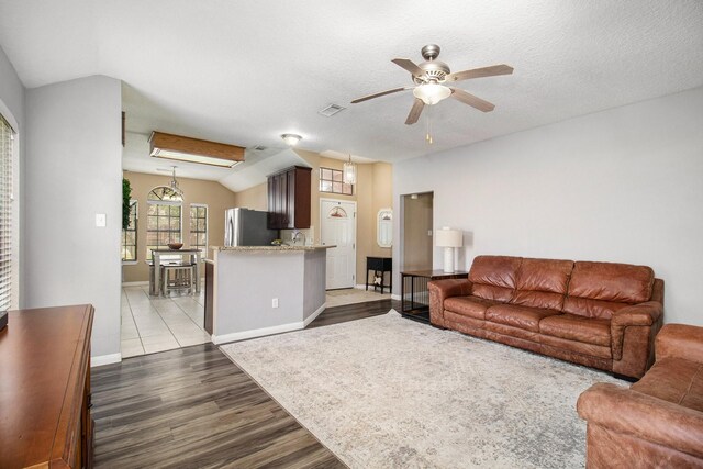 19198 County Road 669e, Alvin, TX 77511 - living room featuring wood finished floors, a ceiling fan, baseboards, and lofted ceiling