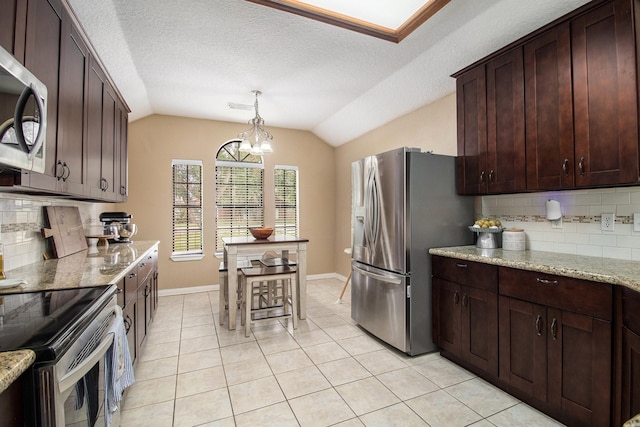 19198 County Road 669e, Alvin, TX 77511 - kitchen with stainless steel appliances, vaulted ceiling, tasteful backsplash, light tile patterned floors, and baseboards