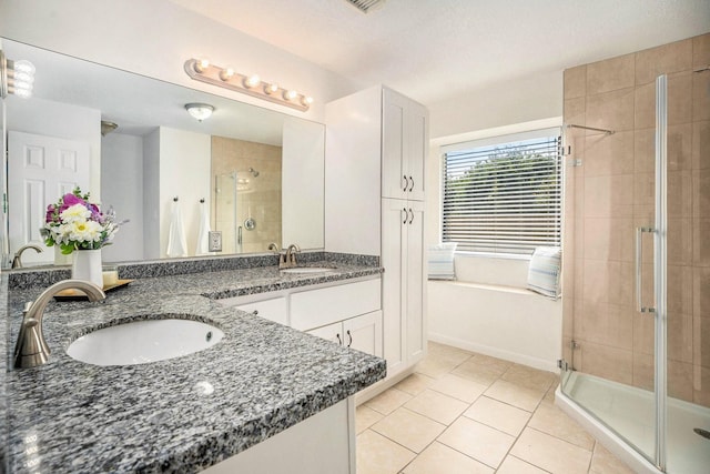 19198 County Road 669e, Alvin, TX 77511 - full bath with a stall shower, double vanity, tile patterned floors, and a bath