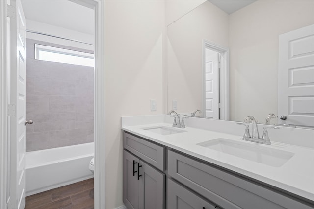 21531 Cypress Trellis Dr, Cypress, TX 77433 - bathroom with toilet, double vanity, wood finished floors, and washtub / shower combination
