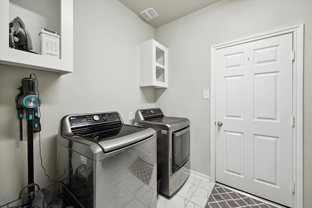 17218 Roxburgh Lake Ln, Hockley, TX 77447 - laundry room with separate washer and dryer, light marble finish floors, and baseboards