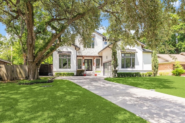 5202 Carew St, Houston, TX 77096 - view of front facade with stucco siding, a garage, stone siding, driveway, and french doors